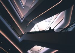 people on the stairs of a highly futuristic building
