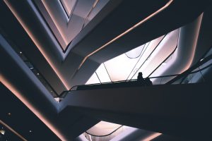 people on the stairs of a highly futuristic building